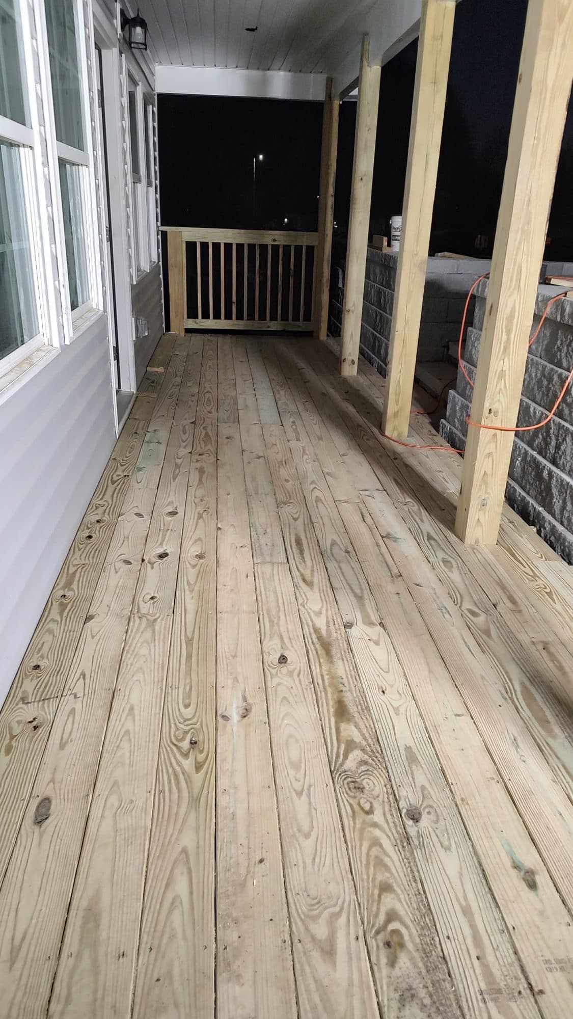 Covered porch with pressure-treated decking and posts