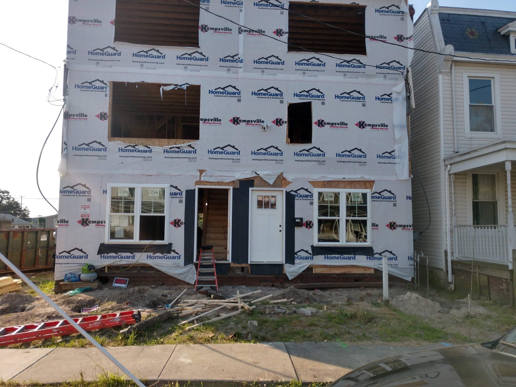 Two-story new home under construction, wrapped and ready for siding